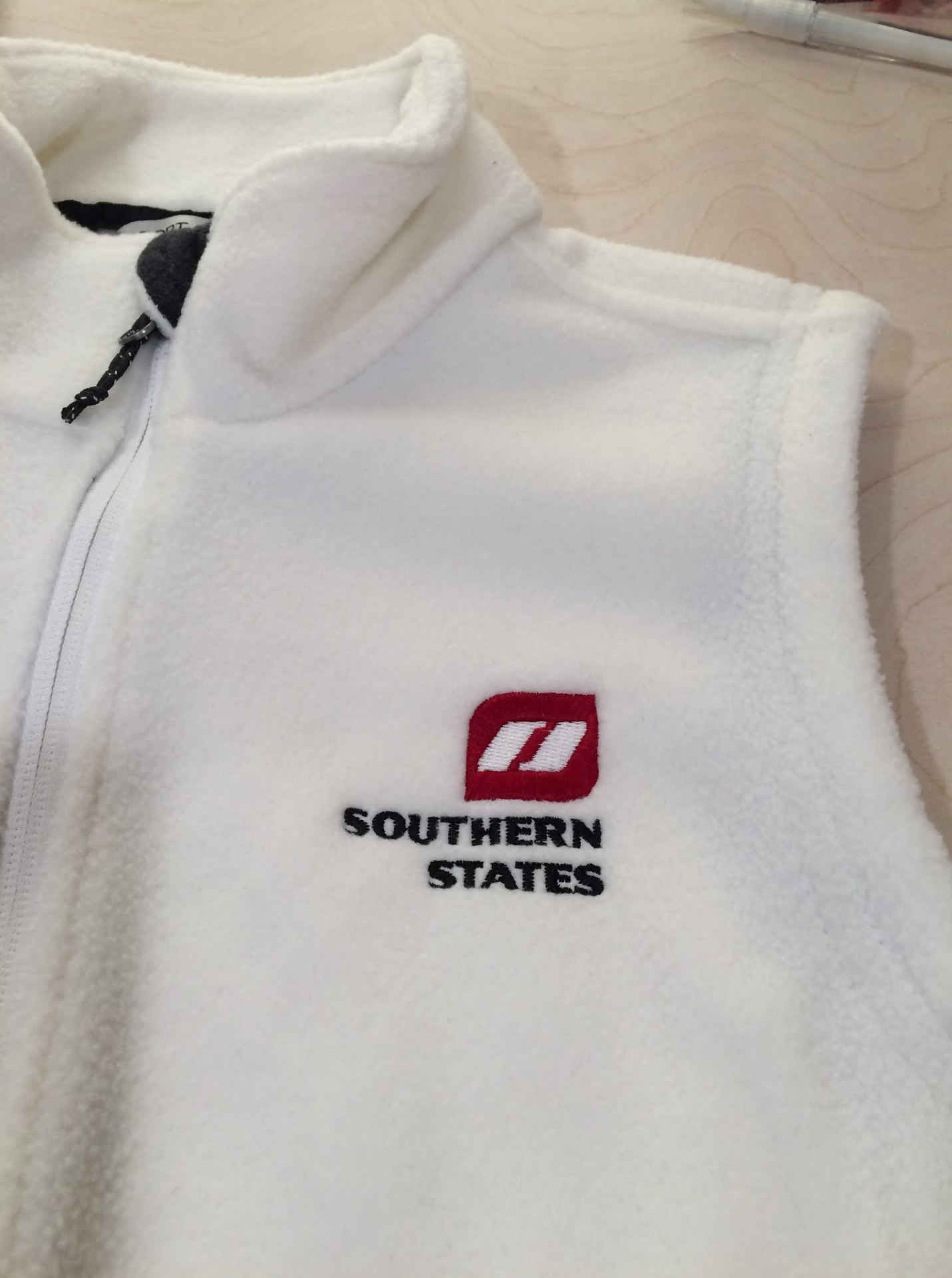 White fleece vest with embroidered Southern States logo