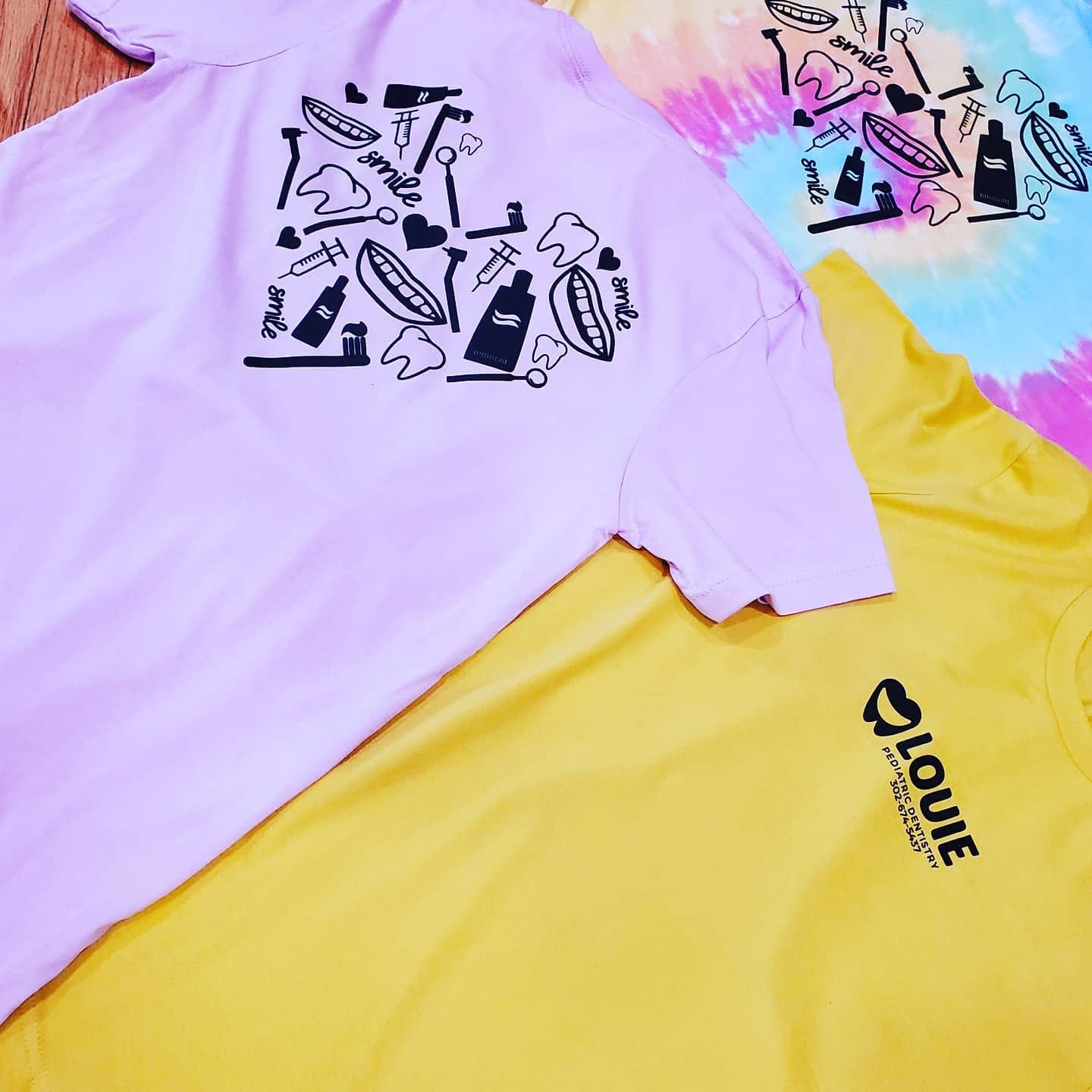 Screen printed pediatric dentistry shirts in lavender, yellow and tie-dye